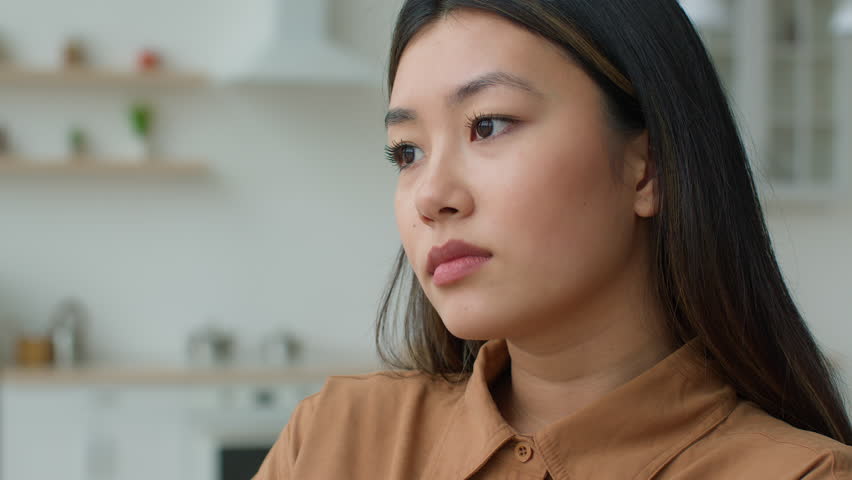 Close up view lonely Asian woman thoughtful pensive korean girl looking in distance deep thoughts worried sight sad alone japanese female businesswoman thinking over problems bad news loss depression | Shutterstock HD Video #1100655717