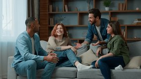 Four ethnic friends fellows companions sit on home couch talking discuss plans chatting friendly talk indoors gathered multiethnic men and women converse joking laughing sharing news real friendship - Powered by Shutterstock - Get 15% off with code: PIKWIZARD15