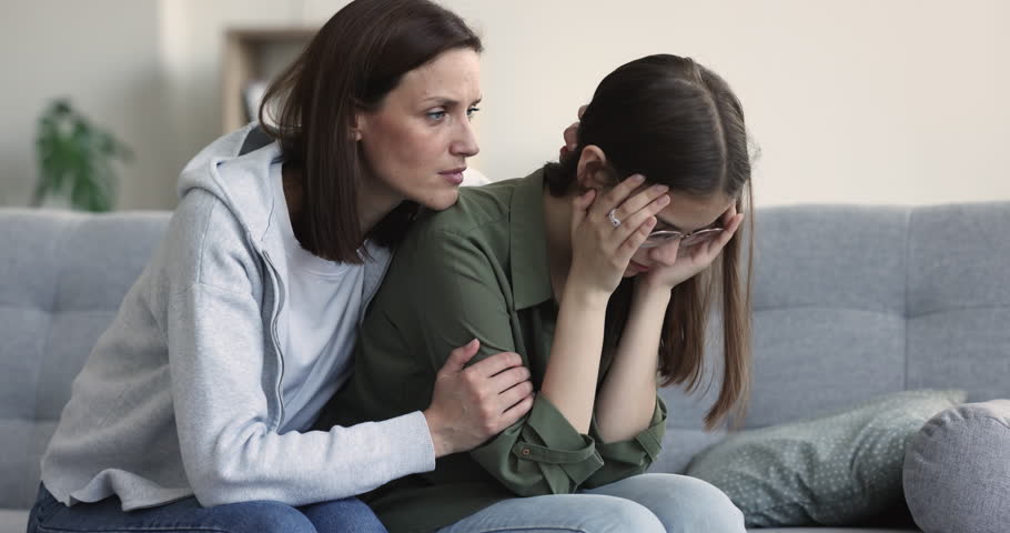Loving concerned mum consoles upset teenager daughter feels unhappy, failed exam, unsuccessful college admission, first unrequited love, betrayal of friend, break up. Teen problem, motherhood, support Royalty-Free Stock Footage #1100656595