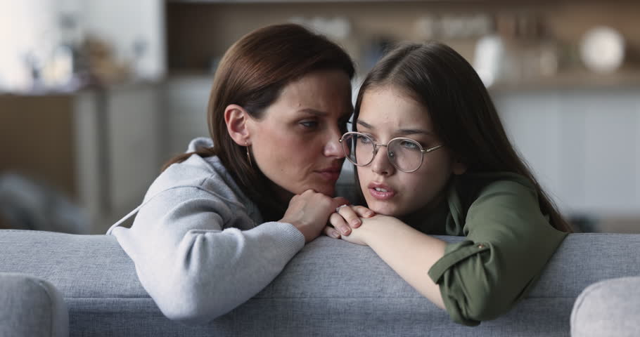 Close up caring mature mum stroke teen daughter hair comforting, soothes, talks to her, supporting in unpleasant situation, first unrequited love, is near, express love, help with wise motherly advice Royalty-Free Stock Footage #1100656599