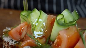 Preparing food in kitchen. Vegetarian sandwich. Chef pours olive oil over sandwich with cheese, tomatoes, cabbage, watercress and pesto. Selective focus. Slow motion video. High quality 4k footage - Powered by Shutterstock - Get 15% off with code: PIKWIZARD15