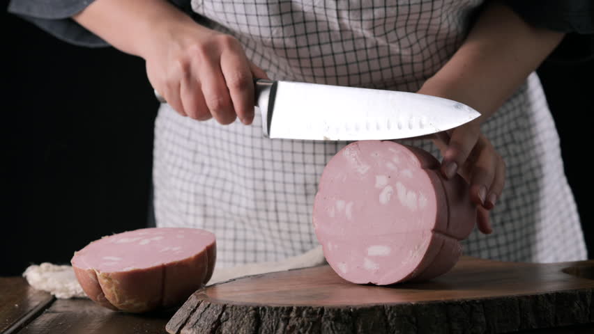 Mortadella. Traditional pork sausage with pistachios or black pepper. Italian delicacy from Bologna. High quality 4k footage
