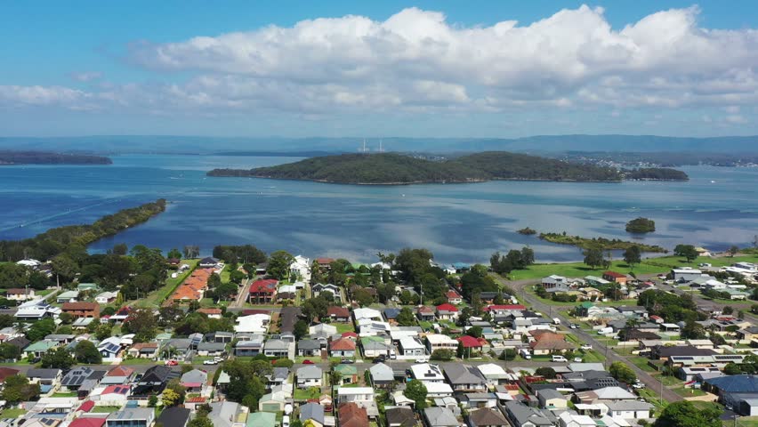 Aerial flying over Swansea town streets to Lake Macquarie shores as 4k.
 Royalty-Free Stock Footage #1100664863