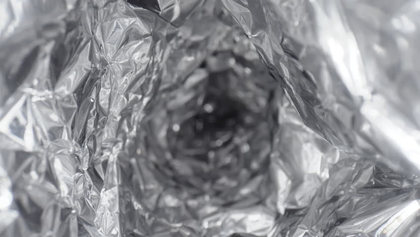 Extreme close-up glide dolly shot of aluminium foil tunnel, shiny crumpled silver metal texture shot with laowa probe lens, pipe, corridor, mashed metal paper abstract pattern Royalty-Free Stock Footage #1100667191