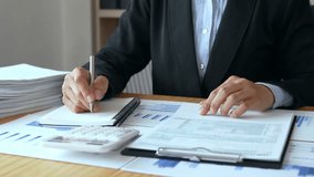 Businesswoman Calculating Tax At Desk - Powered by Shutterstock - Get 15% off with code: PIKWIZARD15