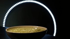 Noodles with led illumination. Background for restaurant description design. Instant egg noodles and black background on a plate