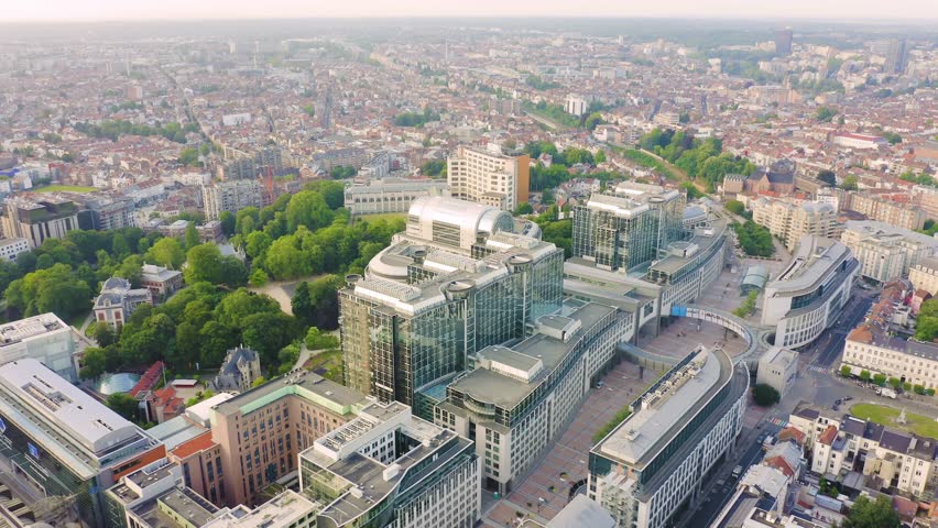 Inscription on video. Brussels, Belgium. The complex of buildings of the European Parliament. State institution. Lightning strikes the letters, Aerial View, Point of interest