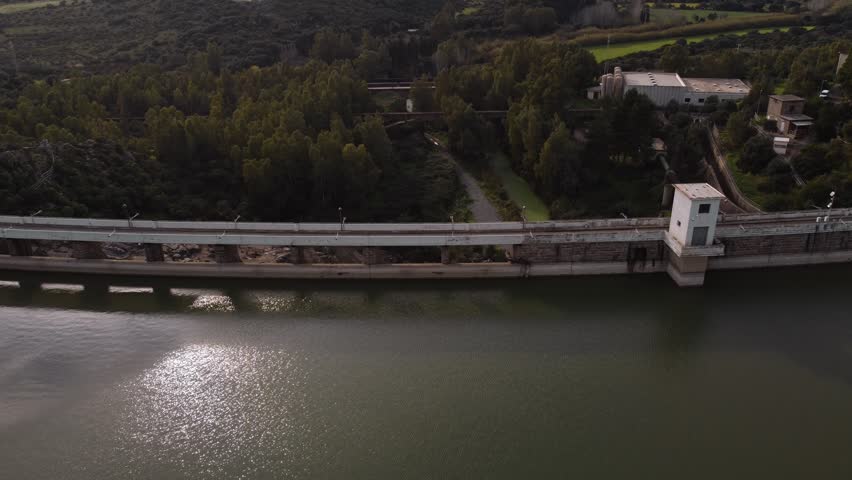 Establisher aerial of Tratalias dam reveals industrial and natural panorama, day