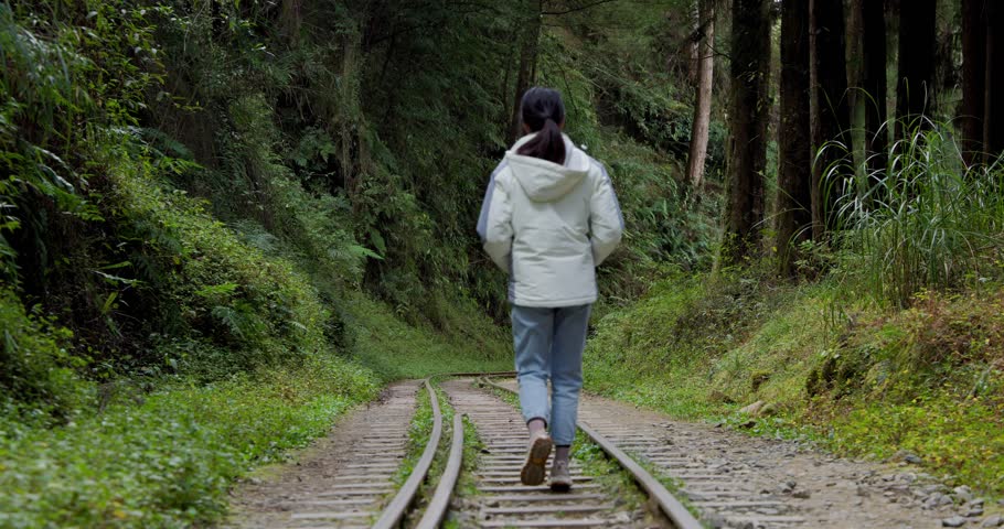 Woman walk on Alishan Forest Railway in Taiwan