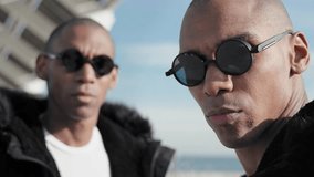 Portrait of two black brother twins wearing sunglasses - African American trendy music band 