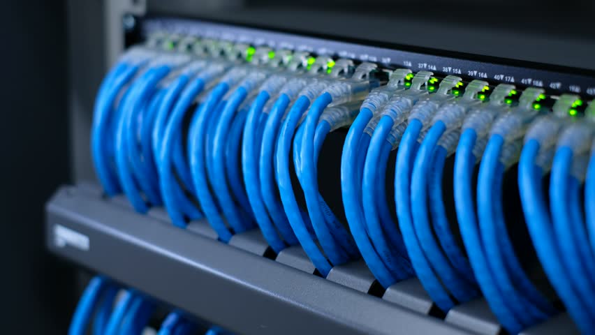 Network Administrator is testing network cable on network switch unplug and plug in cable for maintenance. LED port status is blink.  Royalty-Free Stock Footage #1100677067