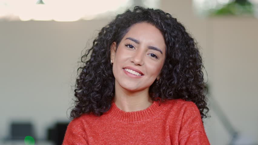 Young smiling happy professional latin business woman leader, happy female company worker or confident corporate manager agent standing in modern office, looking at camera, headshot portrait. Royalty-Free Stock Footage #1100677303