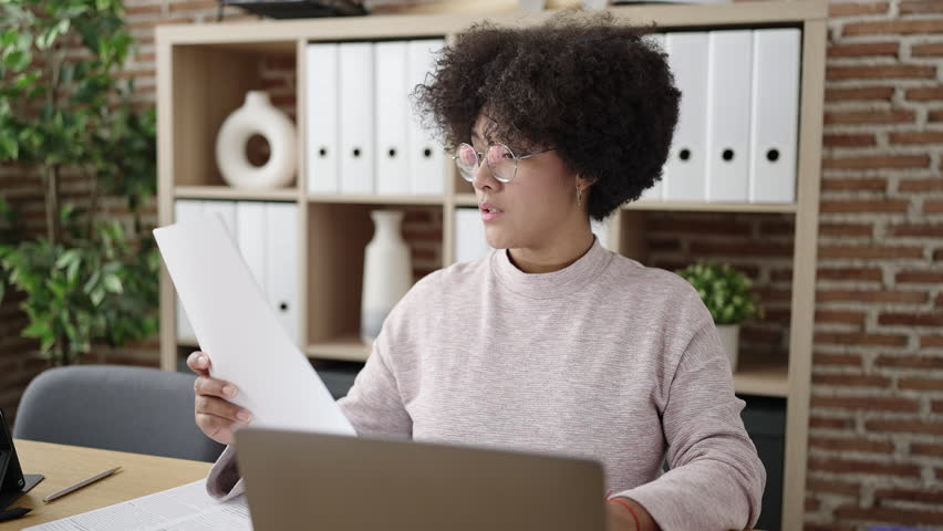 Young african american woman business worker reading document using computer at office | Shutterstock HD Video #1100679867