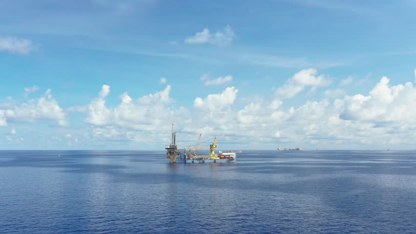 An aerial view from a drone of  a tender drilling oil rig (Barge Oil Rig) on the production platform on sunny day
 Royalty-Free Stock Footage #1100680553
