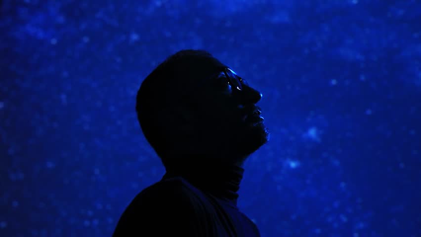 Silhouette of a man with Milky Way starry skies.	
