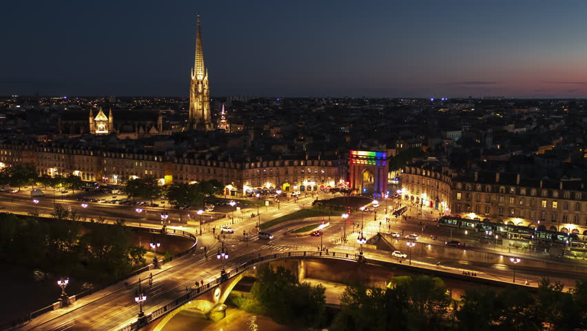 Establishing Aerial View Shot of Bordeaux Fr, world capital of wine, Nouvelle-Aquitaine, France at night, evening, city center tracking right