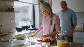 Happy senior couple cooking together at home. - Powered by Shutterstock - Get 15% off with code: PIKWIZARD15