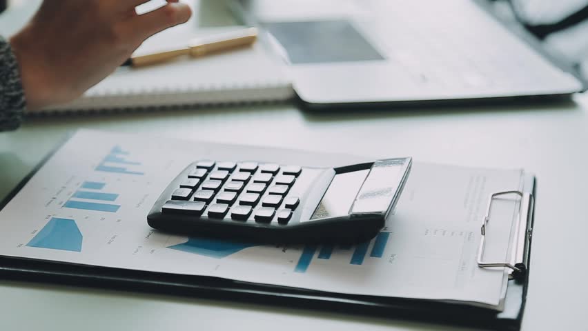 Financial Business meeting analyze tax graph calculator company's performance to create profits and growth, Market research reports and income statistics, Financial and Accounting concept.

 | Shutterstock HD Video #1100683625