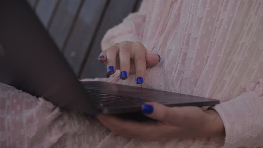 Hand scrolling on a laptop touchpad in park