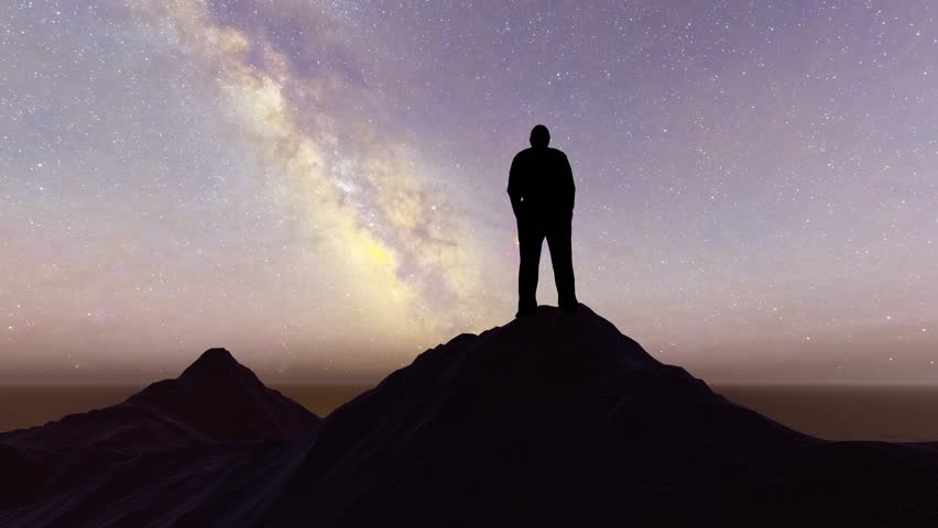 Silhouette of a man standing on the top of the mountain at night | Shutterstock HD Video #1100689825