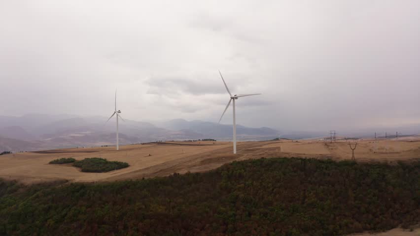 Windmills in a field of Georgia. Drone view. Autumn in the valley.