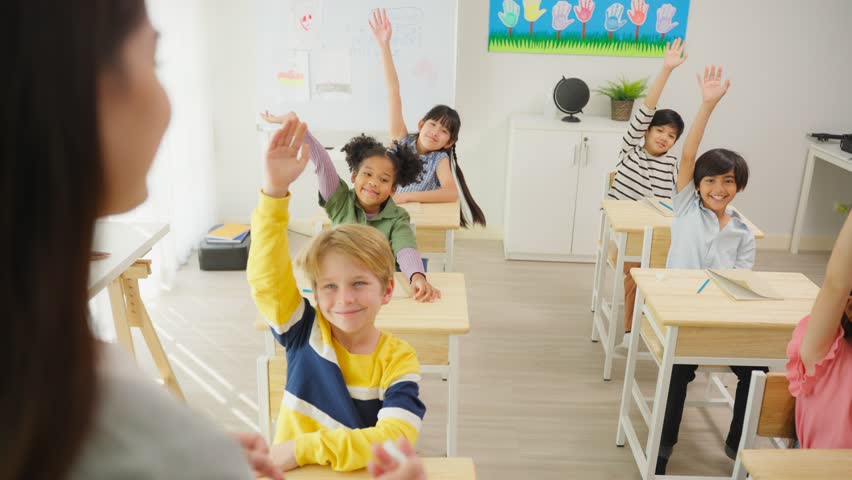 Group of student learn with teacher in classroom at elementary school. Attractive beautiful female instructor master explain and educate young children with happiness and fun activity at kindergarten. | Shutterstock HD Video #1100690161