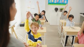 Group of student learn with teacher in classroom at elementary school. Attractive beautiful female instructor master explain and educate young children with happiness and fun activity at kindergarten. - Powered by Shutterstock - Get 15% off with code: PIKWIZARD15