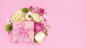 4k Happy mother's day, women's day, valentine's day or birthday holiday. Pastel pink background. Gift box beautifully decoreted natural flowers. Floral flat cards. Copy space. Stop motion animation. - Powered by Shutterstock - Get 15% off with code: PIKWIZARD15
