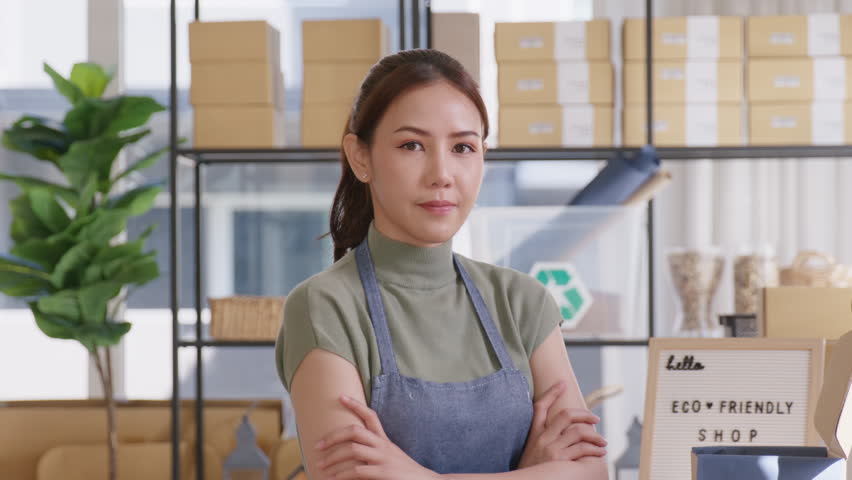 Go green use eco friendly packaging box in net zero waste store asian seller retail home office shop. Small SME owner young adult asia Gen Z people happy relax smile pride arm cross looking at camera. Royalty-Free Stock Footage #1100693189