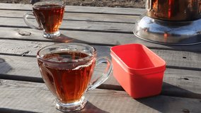 The hand of the man mixing the sugar in the tea in the glass. a cup of black Turkish tea. - Powered by Shutterstock - Get 15% off with code: PIKWIZARD15