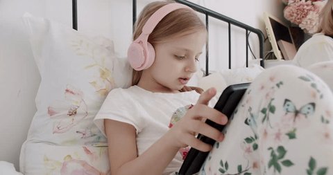Premium Photo  Boy kid and headphones with tablet on bed for online games  watching movies or play educational app happy child digital technology or  listening to multimedia music or streaming cartoon