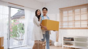 Asian young happy new marriage couple moving to new house together. Attractive romantic man and woman holding box parcel and suitcase with happiness and love. Family-Moving house relocation concept. - Powered by Shutterstock - Get 15% off with code: PIKWIZARD15