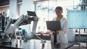 Tracking Portrait of Young Black Female Specialist in Lab Coat Using Laptop Computer to Test an AI Robotic Prototype. Professional, Successful Woman Working as an Engineer in High Tech Company Startup - Powered by Shutterstock - Get 15% off with code: PIKWIZARD15