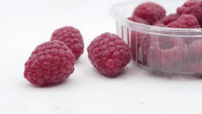4k video raspberries inside package , white background