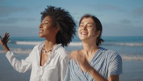 Two girls talking sea shore closeup. Carefree lesbian couple walking ocean coast in sunlight. Smiling multiethnic women partners sharing news going sandy beach. Best friends spending weekend outdoors. - Powered by Shutterstock - Get 15% off with code: PIKWIZARD15