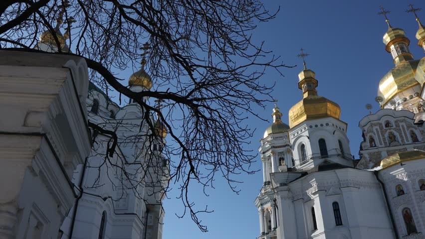 Beautiful view of the Assumption Cathedral of the Kiev-Pechersk Lavra. View of the cathedral from the outside. Beautiful golden domes and blue skies.