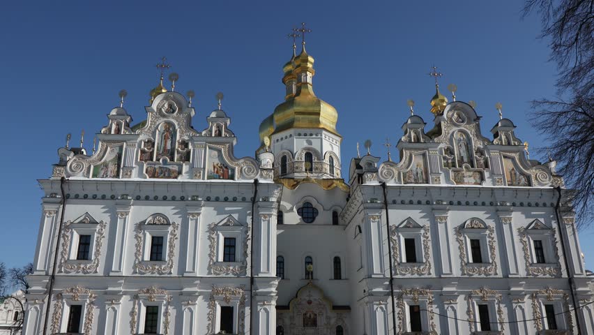 Beautiful view of the Assumption Cathedral of the Kiev-Pechersk Lavra. View of the cathedral from the outside. Beautiful golden domes and blue skies.
