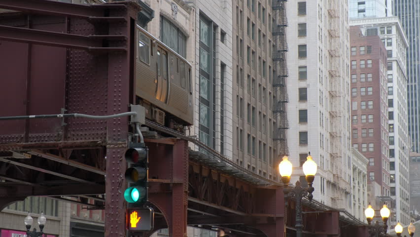 Metra train in Chicago Magnificent Mile street on a Cloudy Day. CHICAGO, USA - JANUARY 3, 2023