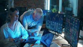 A man and a woman are monitoring stock data on the computers. Teamwork concept. - Powered by Shutterstock - Get 15% off with code: PIKWIZARD15