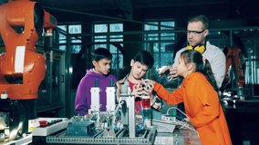 Children and their robotics tutor are studying robotic devices at a school lab - Powered by Shutterstock - Get 15% off with code: PIKWIZARD15
