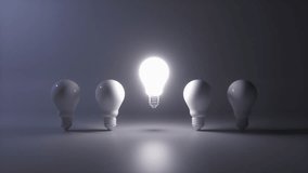 Creative new idea concept with light bulbs. One light bulb standing out from others bulbs floating on dark background. Business, success, think positive, inspiration, solution symbol. 3D Animation. - Powered by Shutterstock - Get 15% off with code: PIKWIZARD15