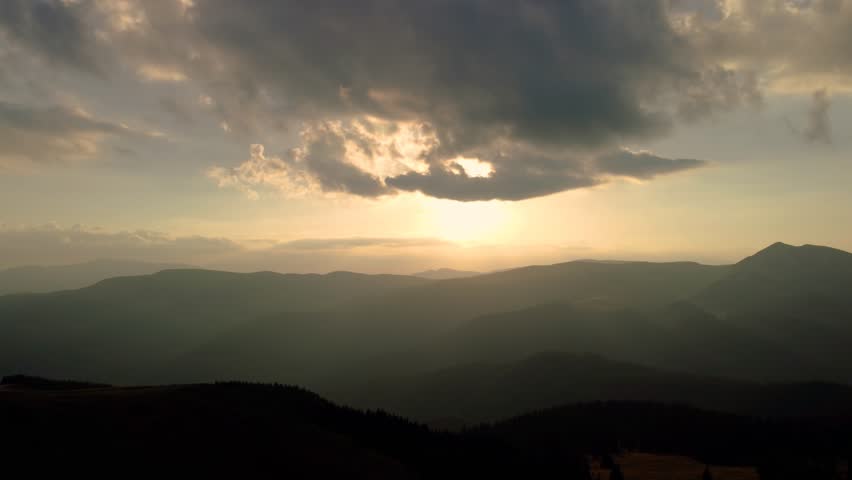 Aerial drone footage of sunset in mountain and hill environment