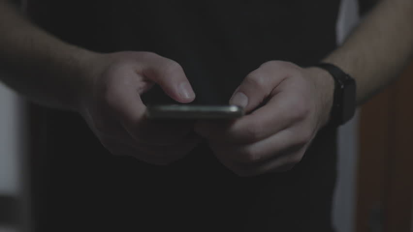 Doom scrolling. Hands of bored man scrolls page app on mobile phone. Browsing internet or social network. Compulsive scrolling concept. Front view Royalty-Free Stock Footage #1100709161