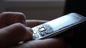 Close-up male hands are using an old push-button mobile phone from the past. Technology development concept. - Powered by Shutterstock - Get 15% off with code: PIKWIZARD15