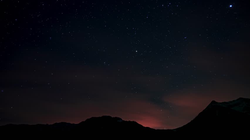 The Milky Way Galaxy moving over the mountain ridge in Italian Alps. Starry night in the mountains Time lapse. Milky way galaxy stars moving over countryside with cloud on the horizon. | Shutterstock HD Video #1100709457
