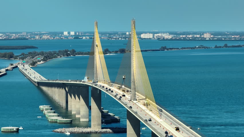 Aerial view of Sunshine Skyway Bridge over Tampa Bay in Florida with moving traffic. Concept of transportation infrastructure Royalty-Free Stock Footage #1100710337