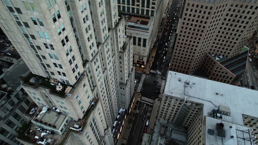 cinematic aerial orbiting while tilting up at the end. Chicago city streets. Establisher shot 4k USA Royalty-Free Stock Footage #1100712065