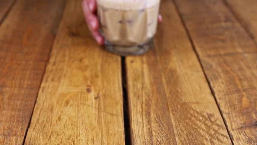 Closeup of kahlua drink with coffee, alcohol and milk on a wooden table | Shutterstock HD Video #1100713851