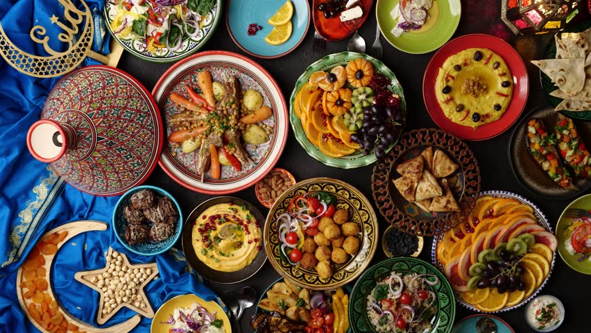Ramadan family dinner. Breaking Fast with Dates. Iftar in the month of Ramadan is a food that Muslims eat after sunset. Arabic Middle Eastern traditional cuisine | Shutterstock HD Video #1100715003