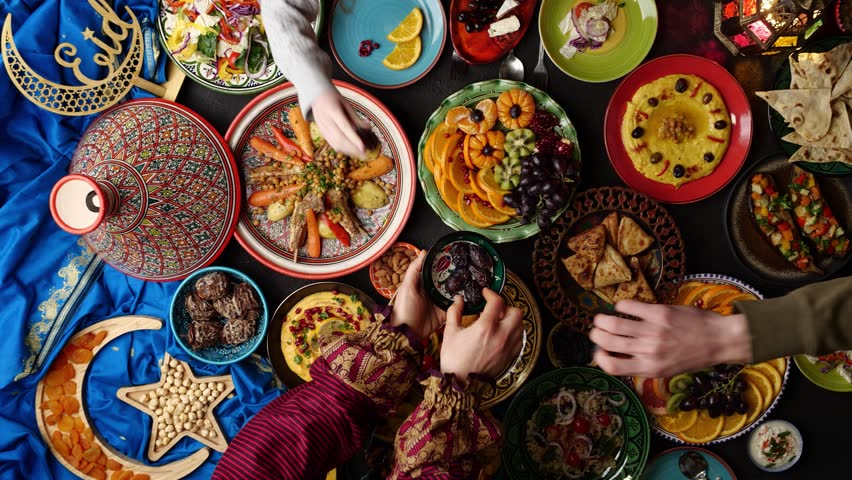 Ramadan family dinner. Breaking Fast with Dates. Iftar in the month of Ramadan is a food that Muslims eat after sunset. Arabic Middle Eastern traditional cuisine | Shutterstock HD Video #1100715003